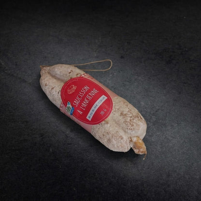 Old-style Bleu-Blanc-Coeur dry-cured saucisson, 210 g, with its label on a dark grey background