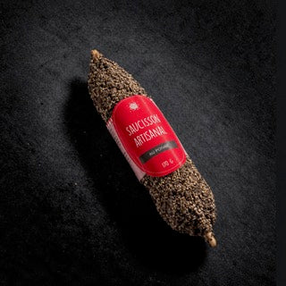 Artisan dry-cured saucisson coated in cracked black pepper, 170 g, with its label on a black slate background