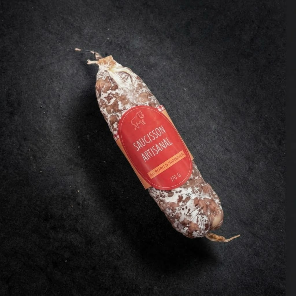 Artisan pork and wild boar dry-cured saucisson, 170 g, with its label on a black slate background