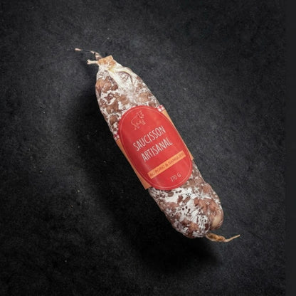 Artisan pork and wild boar dry-cured saucisson, 170 g, with its label on a black slate background